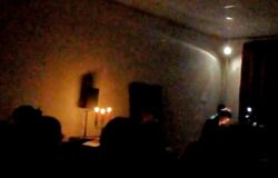 Aufnahme der Veranstaltung 'Mit Wagner auf der Couch'. Man sieht den verdunkelten Innenraum unserer Berliner Musikschule, beleuchtet nur vom Kerzenlicht.